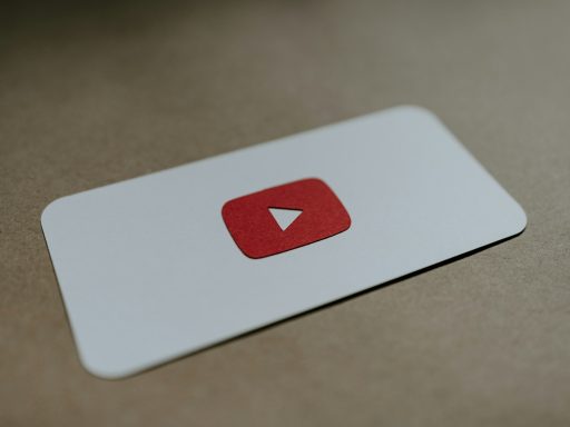 a red and white play button on a white card