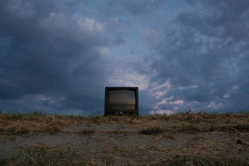 black CRT television on soil