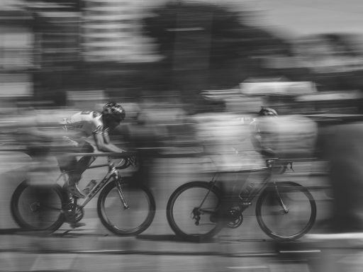 two persons riding on bicycles