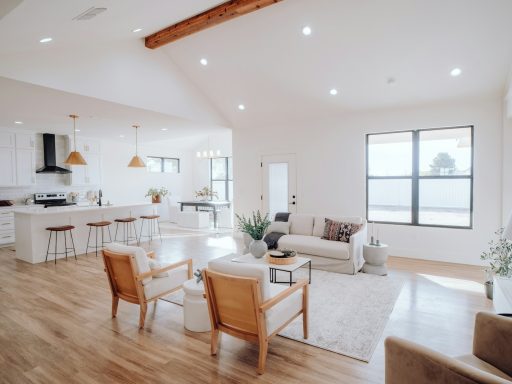 a living room filled with furniture and a kitchen