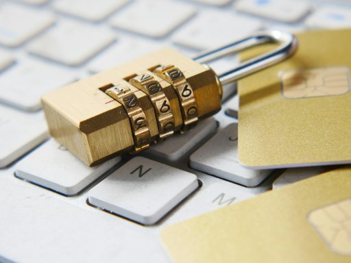 a golden padlock sitting on top of a keyboard