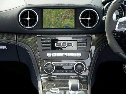 Close-up of a Mercedes Benz car dashboard featuring a navigation system and modern controls.