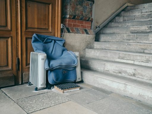 blue and black backpack on gray concrete stairs