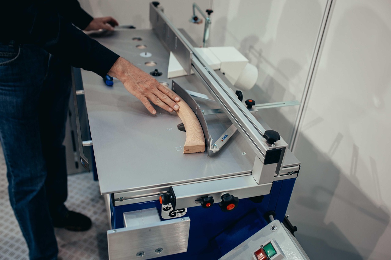 Een excentrische schuurmachine in gebruik op een houten tafelblad